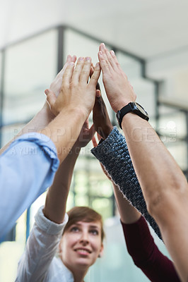 Buy stock photo Cropped shot of a group of people putting their hands up together in unity