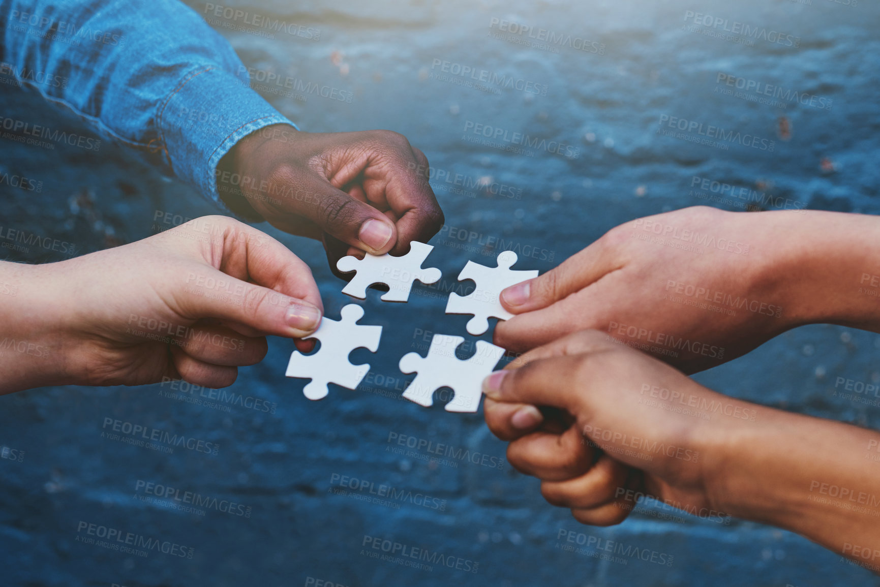 Buy stock photo Cropped shot of four people each holding a puzzle piece to fit together