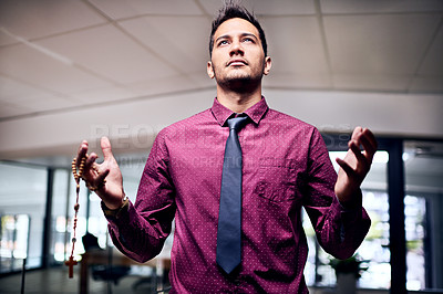 Buy stock photo Cropped shot of a religious businessman standing in his office