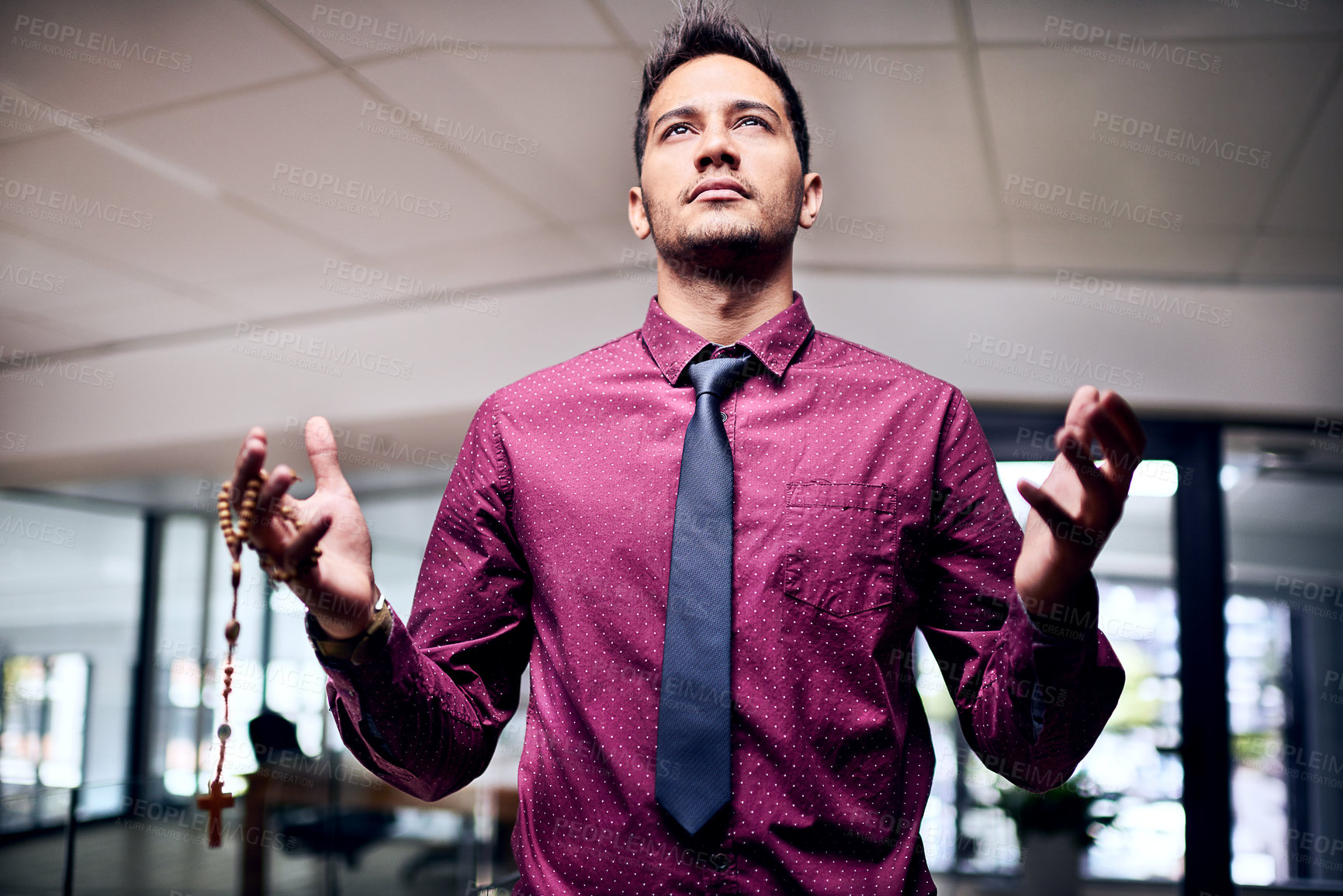 Buy stock photo Cropped shot of a religious businessman standing in his office