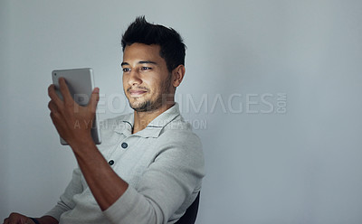 Buy stock photo Night, smile and tablet with business man on space in studio for communication, networking or streaming. Mockup, relax and technology with happy young employee on gray background for research