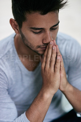 Buy stock photo Shot of a young man praying