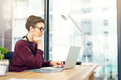 Buy stock photo Office, laptop and woman at creative agency with research, reading and thinking at desk at startup. Website, digital professional and businesswoman at computer checking online review, email or report