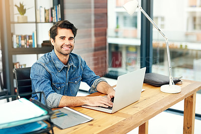 Buy stock photo Portrait of a young designer working on a laptop in a modern office
