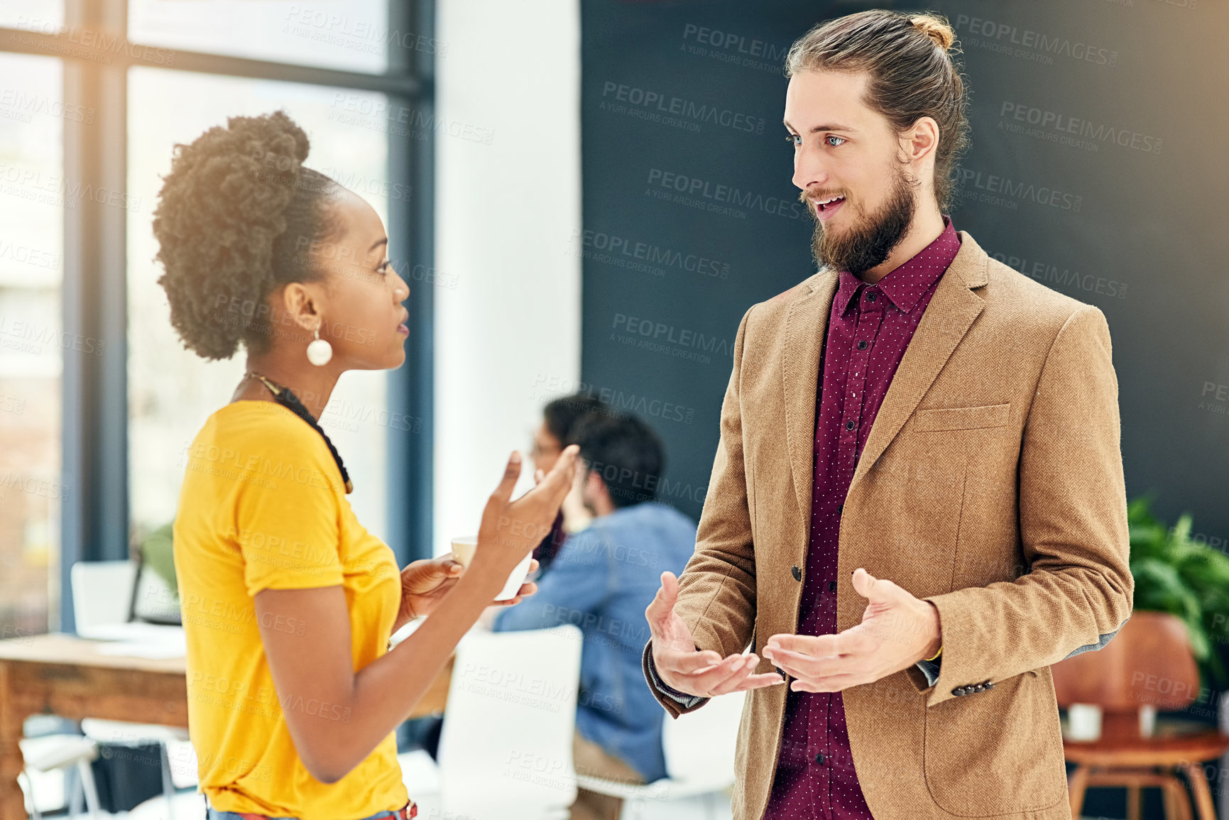Buy stock photo Cropped shot of young creatives having a discussion in a modern office