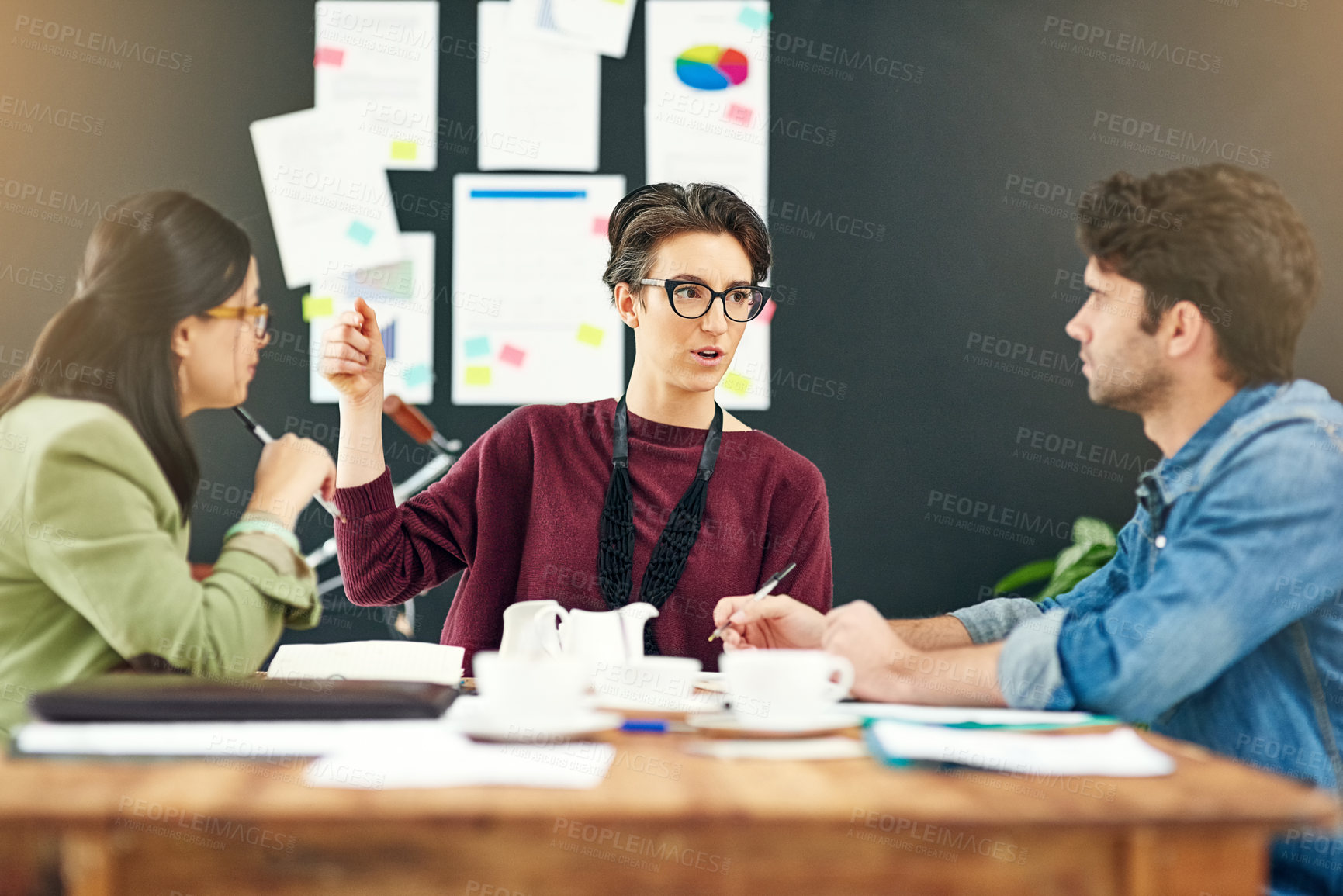 Buy stock photo Cropped shot of young creatives having a meeting in a modern office