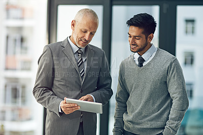 Buy stock photo Mature, man and young male for mentor, tablet and pointing in office for advice in business. Senior, employee and intern on technology in meeting for brainstorming, ideas and vision in corporate

