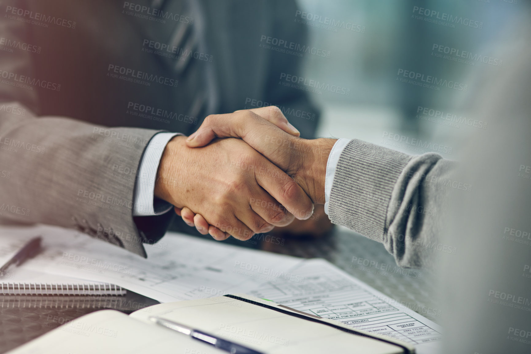 Buy stock photo Businessmen, handshake and deal with paperwork, agreement and notebook in office for business. Male people, employees and colleagues in onboarding for partnership, negotiation and meeting in company
