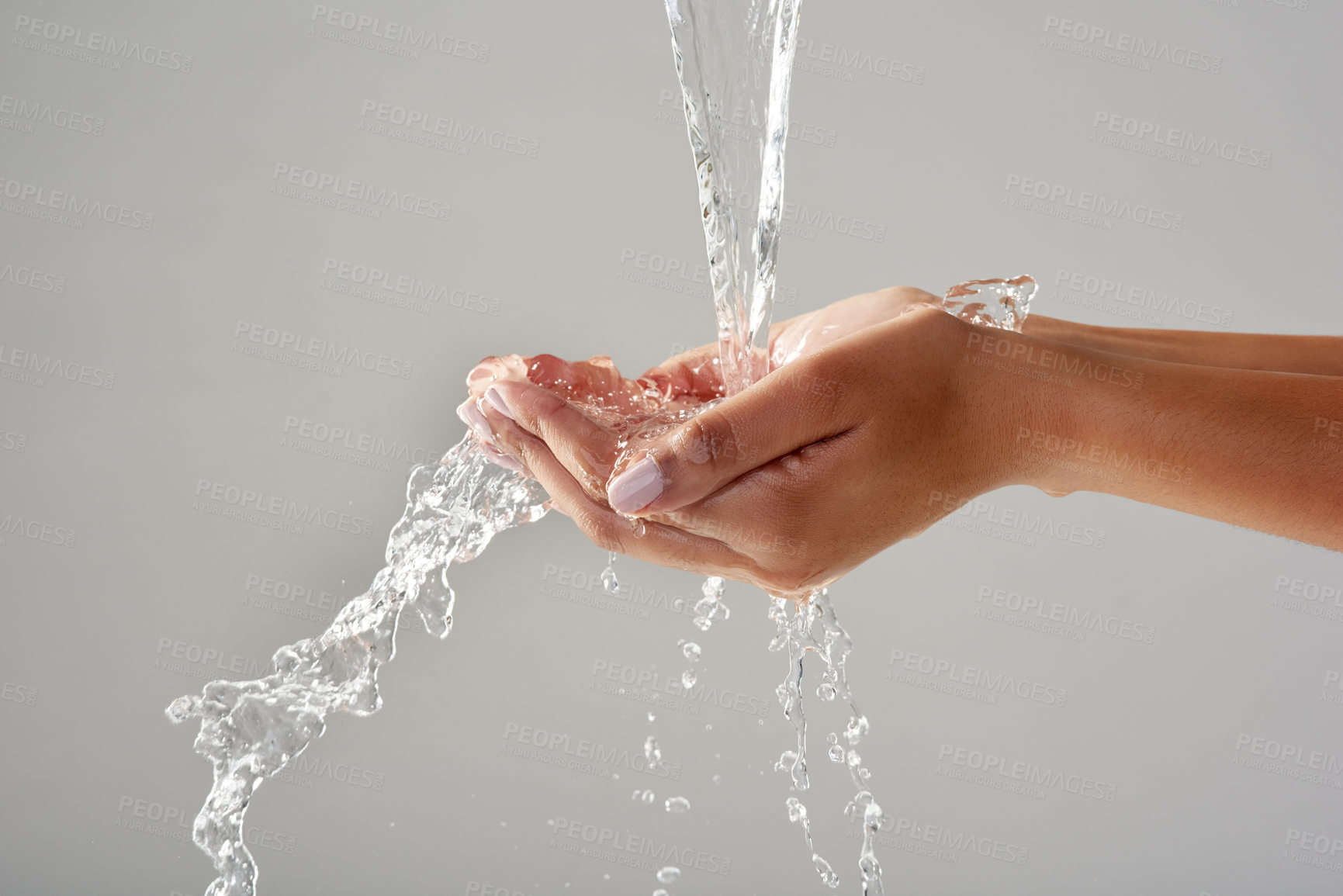 Buy stock photo Hands, water and wash for cleaning, splash and studio in close up, hydration and grey background. Person, wellness and  healthy skincare for disinfection, safety and germs with bacteria or virus 