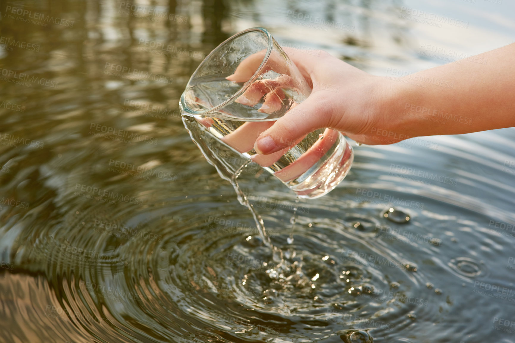Buy stock photo Glass, hands and lake with fresh water for drinking or sustainability with calm in outdoors with splash. Sunshine, spring and wellness with health or clean river with respect for nature with person