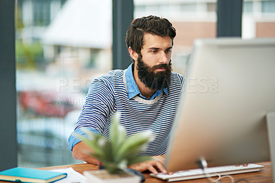 Buy stock photo Cropped shot of a creative businessman working on his computer in the office