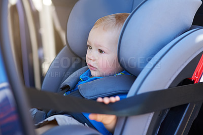 Buy stock photo Cropped shot of an adorable baby boy sitting in a car seat