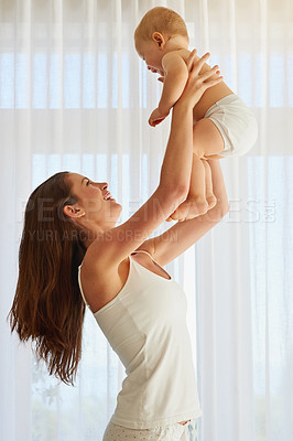 Buy stock photo Cropped shot of a mother spending quality time with her baby boy at home