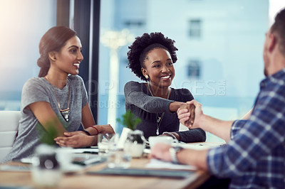 Buy stock photo Cropped shot of two people shaking hands during a meeting