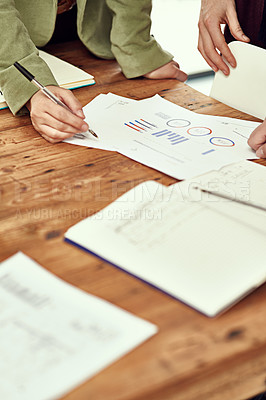 Buy stock photo Closeup shot of businesspeople looking through some paperwork in an office