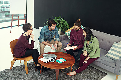 Buy stock photo Shot of a group of young creatives having a meeting in a modern office