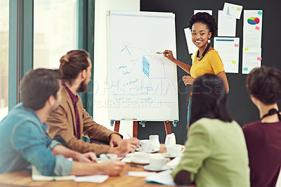 Buy stock photo Cropped shot of a young creative giving a presentation to her colleagues in an office