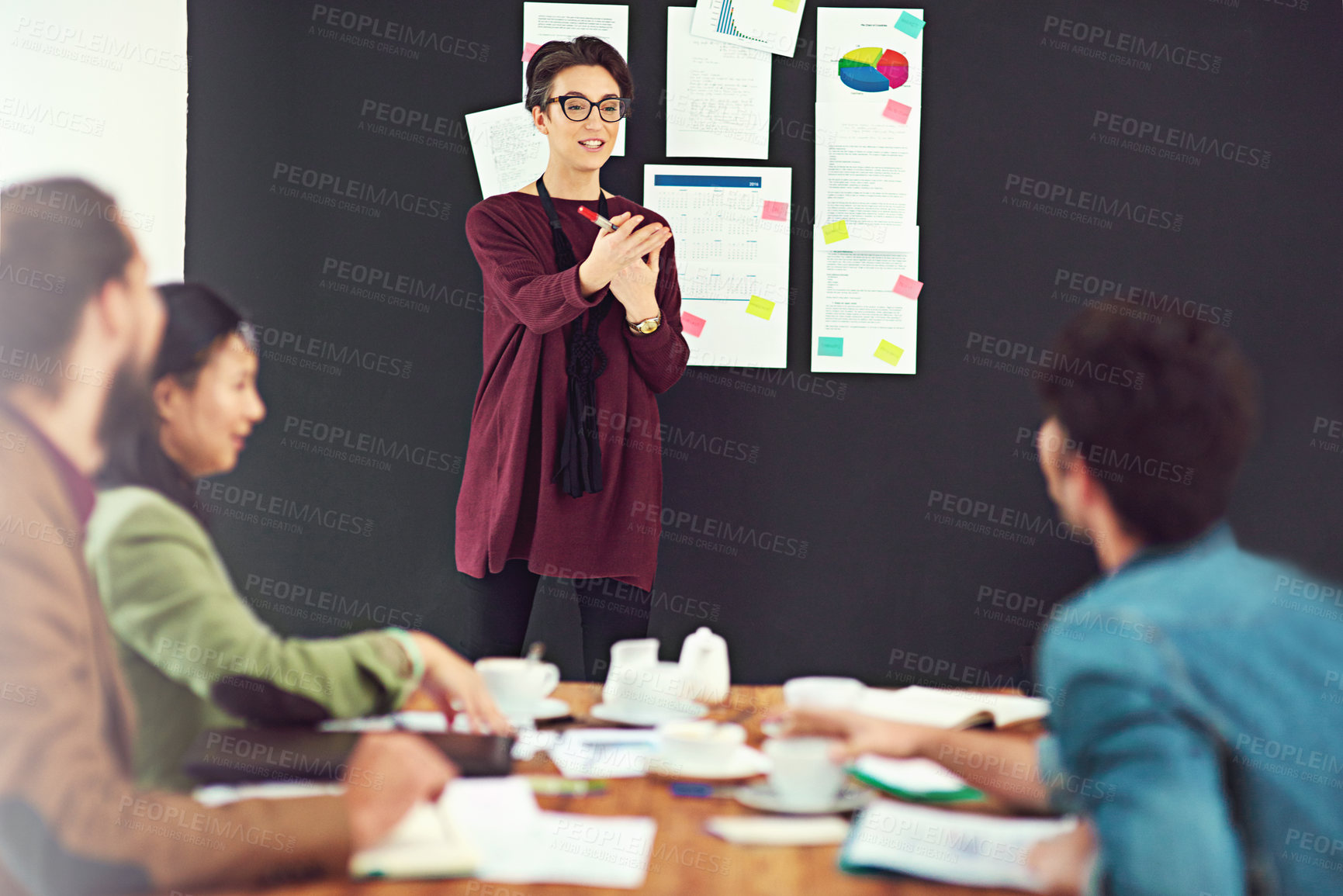 Buy stock photo Creative woman, coach and meeting with team for presentation on company data, growth or statistics at office. Female person or speaker talking to group of employees for revenue or profit in startup