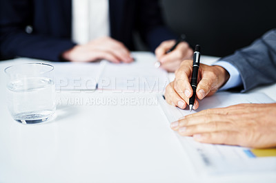Buy stock photo Cropped shot of businesspeople working on paperwork