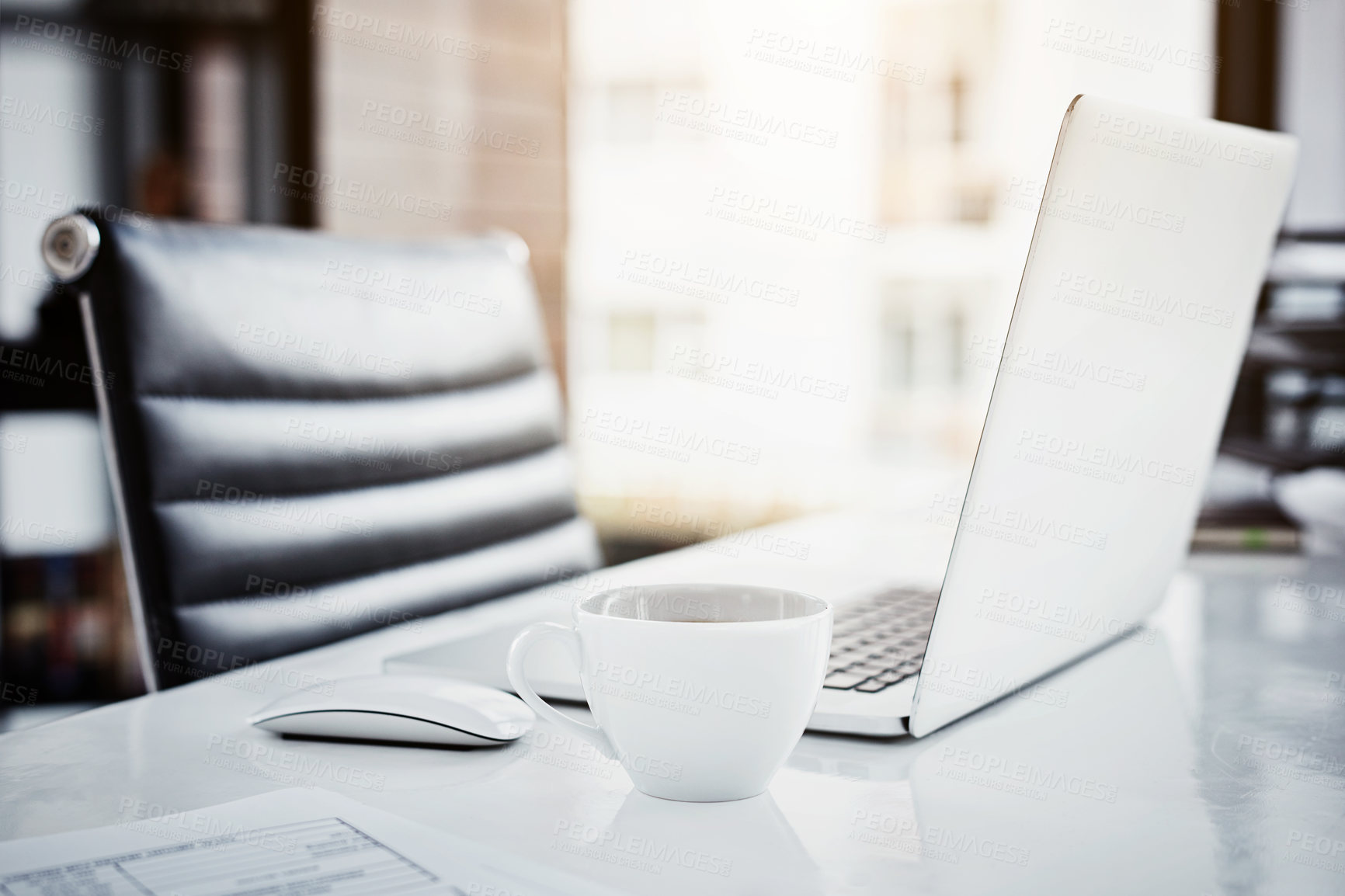 Buy stock photo Closeup shot of a laptop and coffee cup sitting on a desk