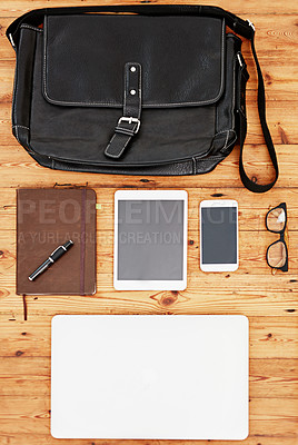Buy stock photo Desk, top view and technology in office for business, glasses and book for schedule planning or journal. Wooden table, digital devices and notebook for corporate work or job, stationary and bag.