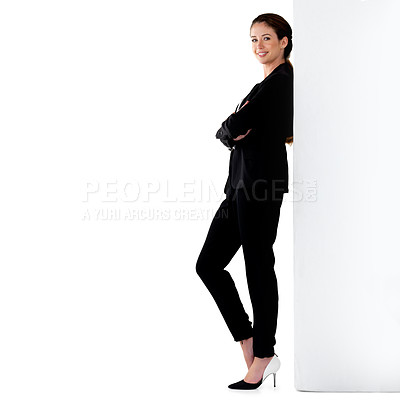 Buy stock photo Studio portrait of a successful young businesswoman leaning against a wall