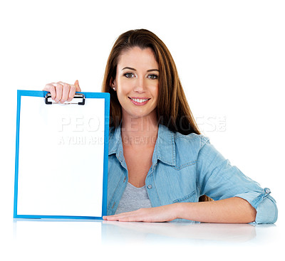 Buy stock photo Studio portrait of an attractive young woman holding a clipboard with a blank piece of paper attached to it against a white background