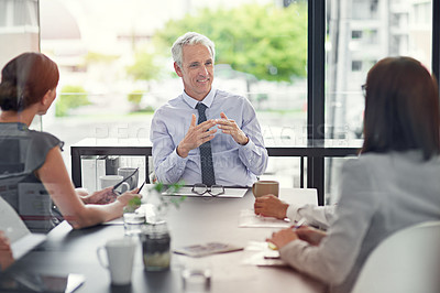 Buy stock photo Cropped shot of a businessman leading a discussion in the boardroom