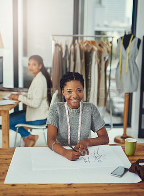 Buy stock photo Shot of a successful young fashionShot of a fashion designer working on her latest creation with her colleague blurred outdesigner