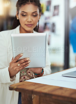 Buy stock photo Cropped shot of a young fashion designer working on her tablet