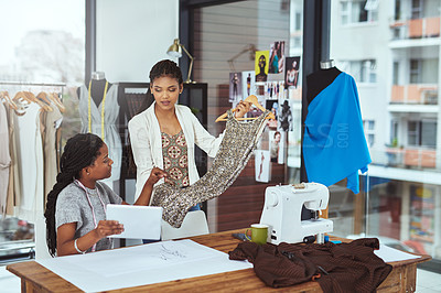 Buy stock photo Cropped shot of two young fashion designers working on their latest piece