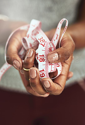 Buy stock photo Cropped shot of an unrecognizable fashion designer holding measuring tape