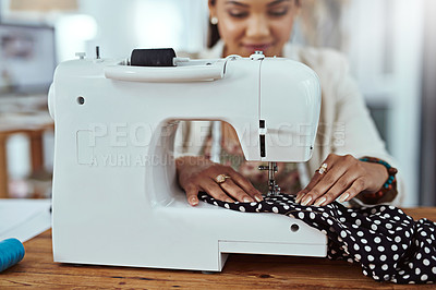 Buy stock photo Cropped shot of a young fashion designer using a sewing machine in her workshop