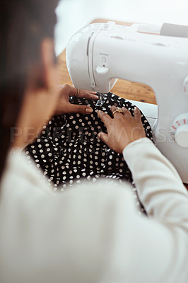 Buy stock photo Rearview shot of a young fashion designer using a sewing machine in her workshop