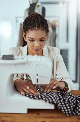 Buy stock photo Cropped shot of a young fashion designer using a sewing machine in her workshop