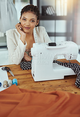 Buy stock photo Cropped portrait of a young fashion designer using a sewing machine in her workshop