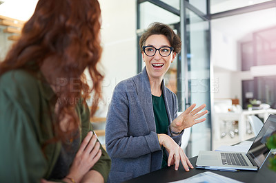 Buy stock photo Woman, talking and laptop with coworker in office, web design on technology with professional female person. Discussion, staff for online career, conversation and collaboration for employee teamwork