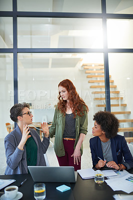 Buy stock photo Talking, teamwork or women in startup for meeting, conversation or discussion for paperwork. Laptop, problem solving and colleagues in office for planning strategy, feedback or idea collaboration