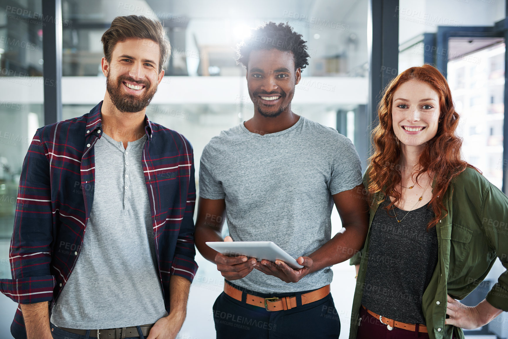 Buy stock photo Portrait of three young creatives working together in a modern office