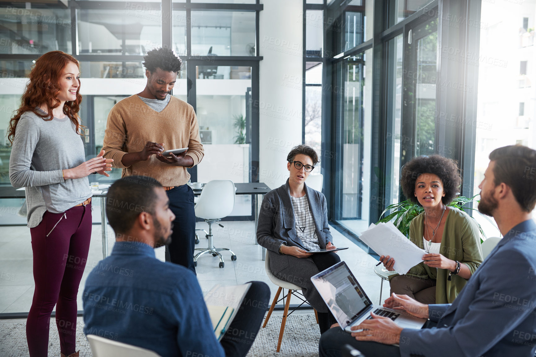 Buy stock photo Cropped shot of a group of young creatives having a meeting in a modern office