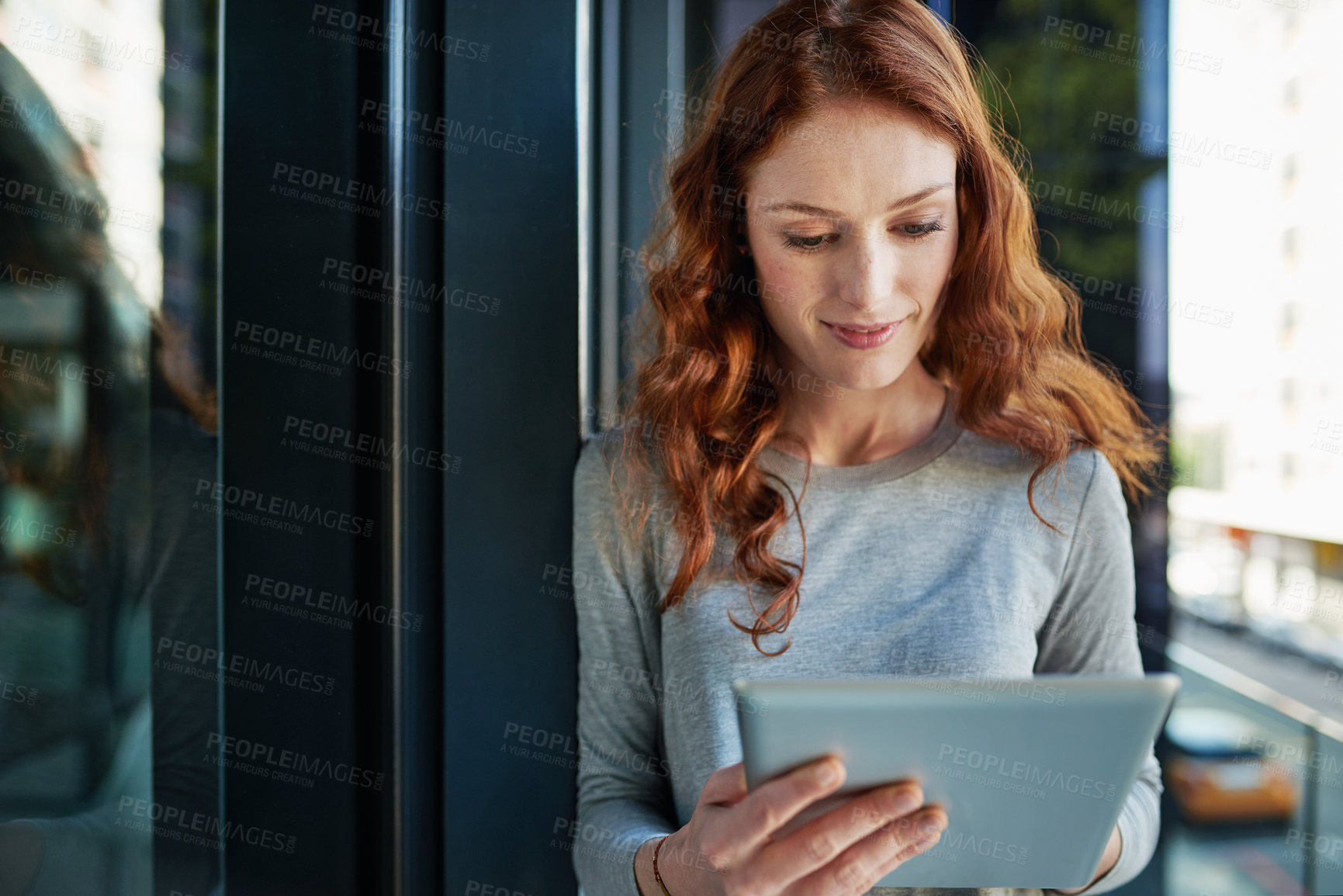 Buy stock photo Cropped shot of a young creative working on a digital tablet outside