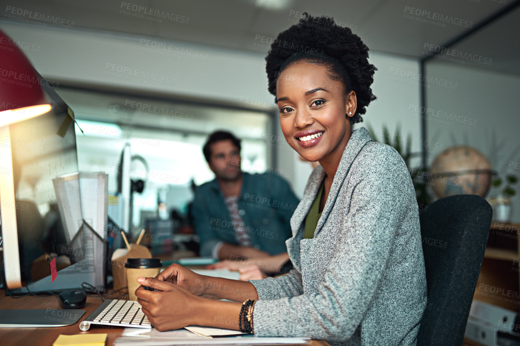 Buy stock photo Cropped portrait of a young designer in the office with her colleagues in the background