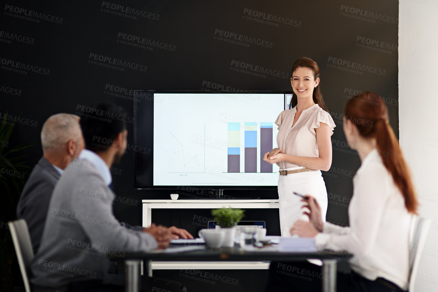 Buy stock photo Cropped shot of a young businesswoman delivering a presentation in a boardroom