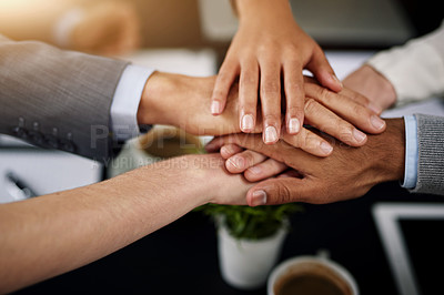 Buy stock photo Closeup shot of a diverse team of colleagues joining their hands together in unity