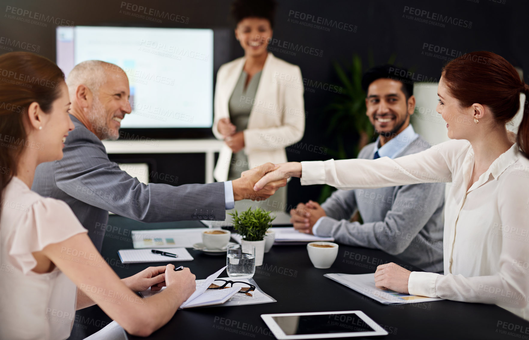 Buy stock photo Presentation, people and happy with handshake for success, deal and teamwork or collaboration. Diversity, boardroom and happy for business achievement with congratulations as ceo or company leader

