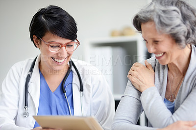 Buy stock photo Cropped shot of a doctor and patient looking at some medical records together