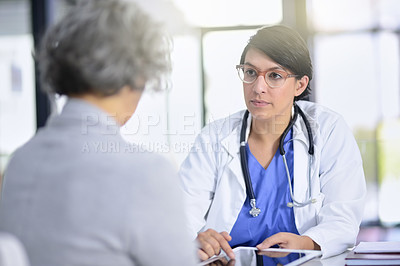 Buy stock photo Cropped shot of a doctor showing a patient something on a digital tablet