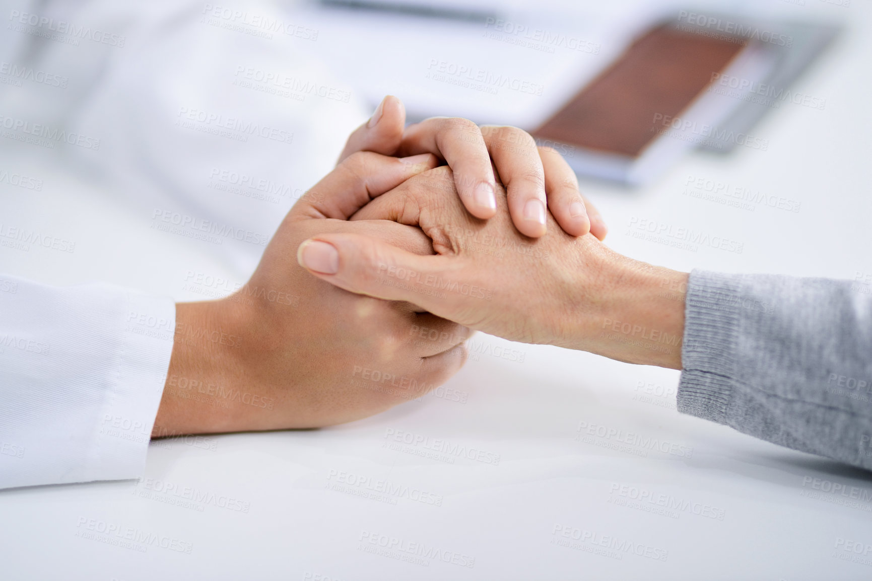 Buy stock photo Closeup shot of a doctor holding a patient's hand in comfort