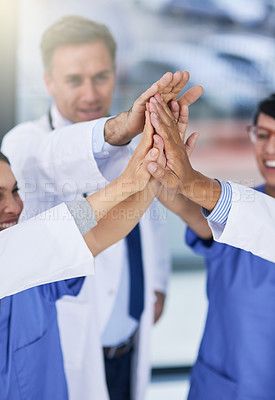 Buy stock photo Closeup shot of medical practitioners giving each other a high five
