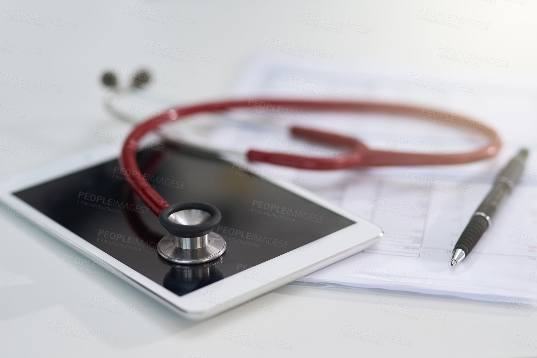 Buy stock photo Cropped shot of a stethoscope on a tablet